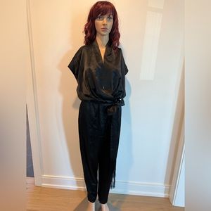 L’Agence black satin jumpsuit with side zipper, angle zips and pretty belt